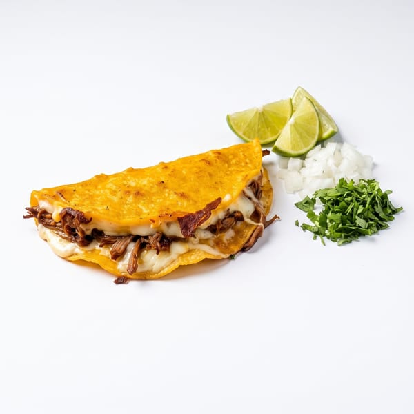 Birria quesataco with lime, onion and cilantro